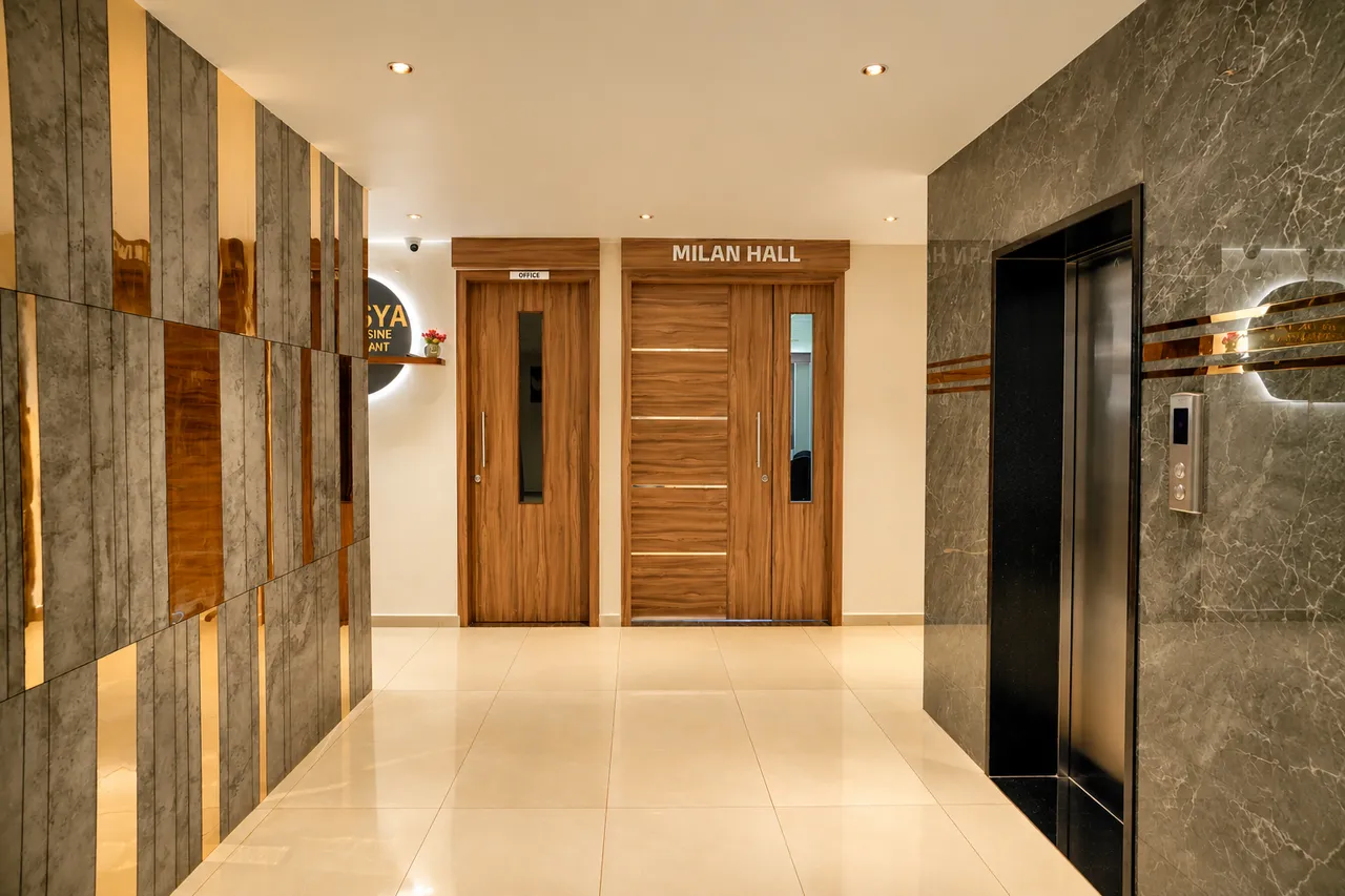 Milan Hall entrance and passenger elevator foyer with marble wall cladding at Hotel Pumerai