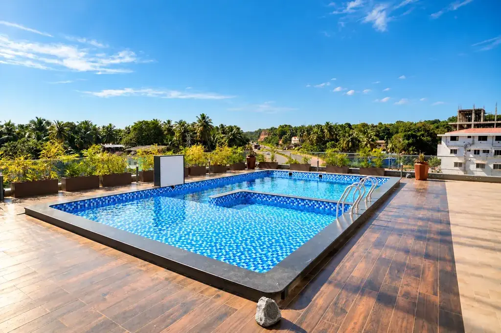 Rooftop glass-edge pool at Hotel Pumerai overlooking coastal canopies
